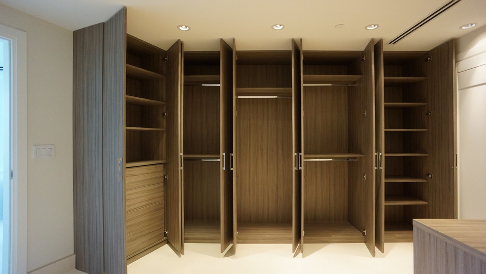 Design ideas for a large contemporary dressing room in Miami with flat-panel cabinets and dark wood cabinets.