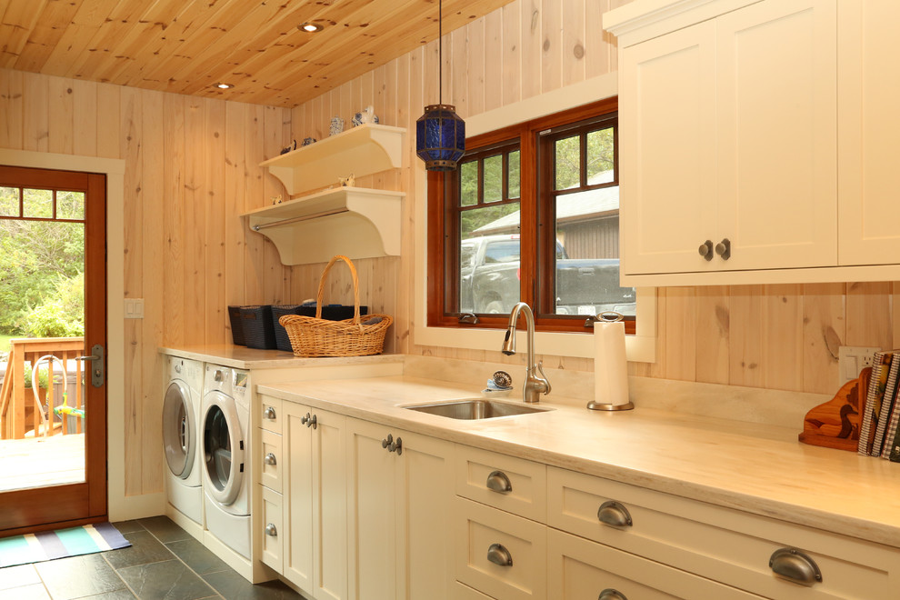 Inspiration for a mid-sized arts and crafts galley utility room in Toronto with an undermount sink, shaker cabinets, white cabinets and a side-by-side washer and dryer.