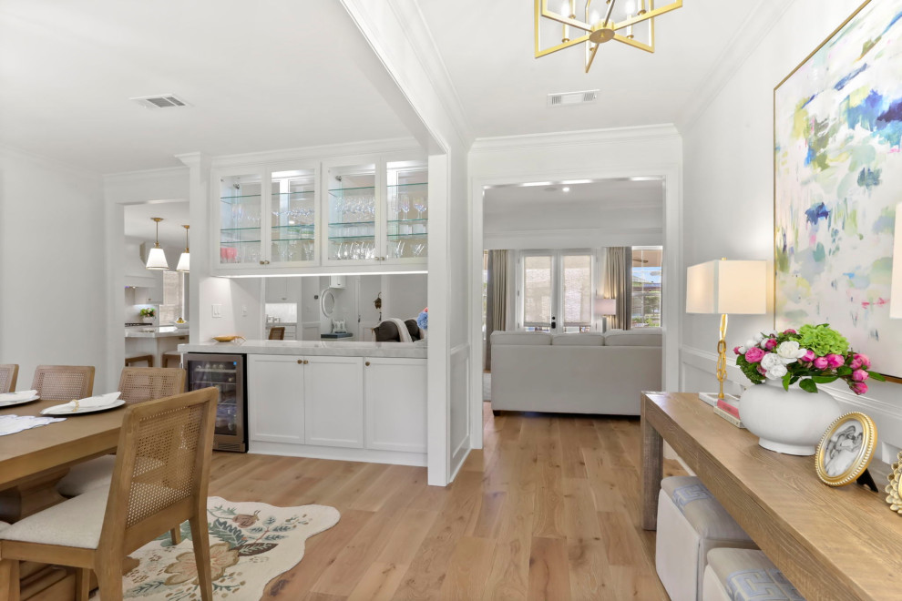 Example of a mid-sized transitional light wood floor and brown floor front door design in New Orleans with white walls