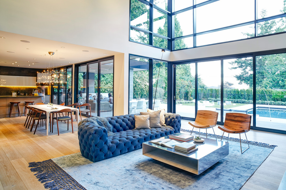 Photo of a mid-sized contemporary formal open concept living room in Vancouver with white walls and light hardwood floors.