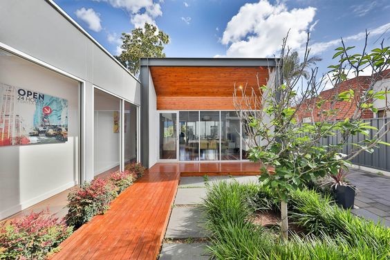 Inspiration for a mid-sized contemporary one-storey grey house exterior in Adelaide with concrete fiberboard siding, a butterfly roof, a mixed roof and a grey roof.