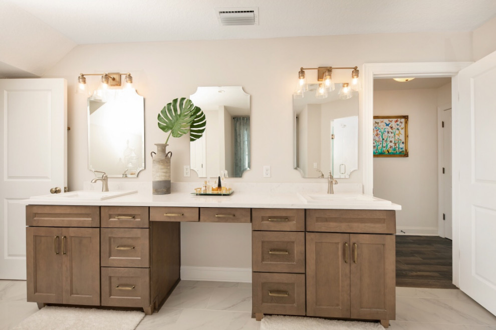 Design ideas for a mid-sized beach style master bathroom with shaker cabinets, dark wood cabinets, a freestanding tub, engineered quartz benchtops, white benchtops, a corner shower, beige walls, marble floors, a drop-in sink, grey floor and a hinged shower door.