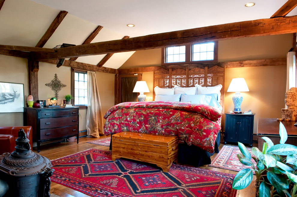 This is an example of a country bedroom in Boston with beige walls.