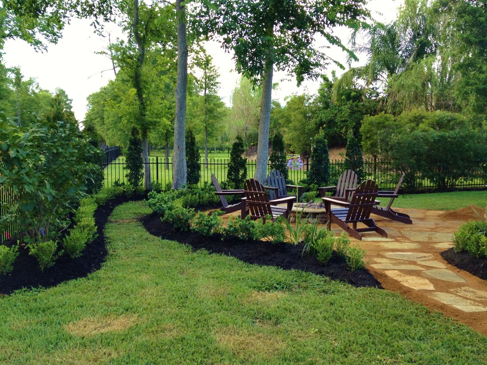 Design ideas for a traditional patio in Houston with a fire feature.