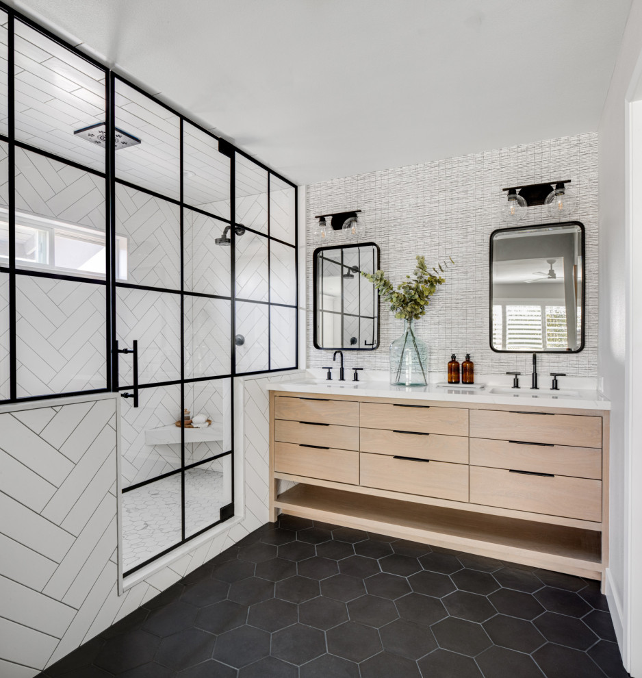 Inspiration for a mid-sized contemporary master bathroom in Orange County with flat-panel cabinets, light wood cabinets, a corner shower, white tile, subway tile, grey walls, porcelain floors, an undermount sink, marble benchtops, black floor, a hinged shower door, white benchtops, an enclosed toilet, a double vanity, a freestanding vanity and wallpaper.