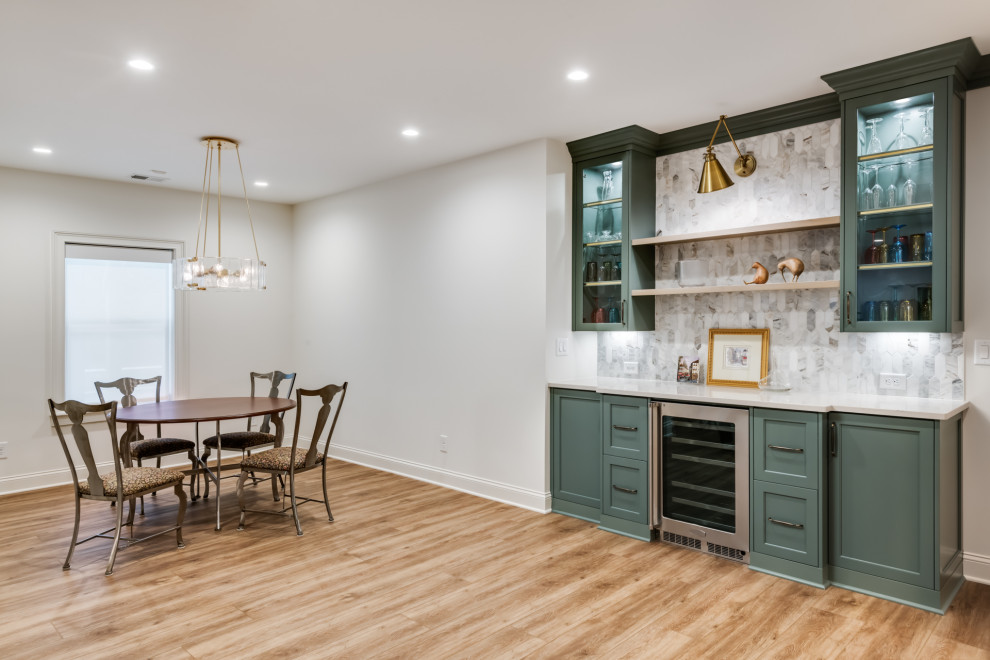 Design ideas for a large classic walk-out basement in Atlanta with a home bar, white walls, vinyl flooring and beige floors.
