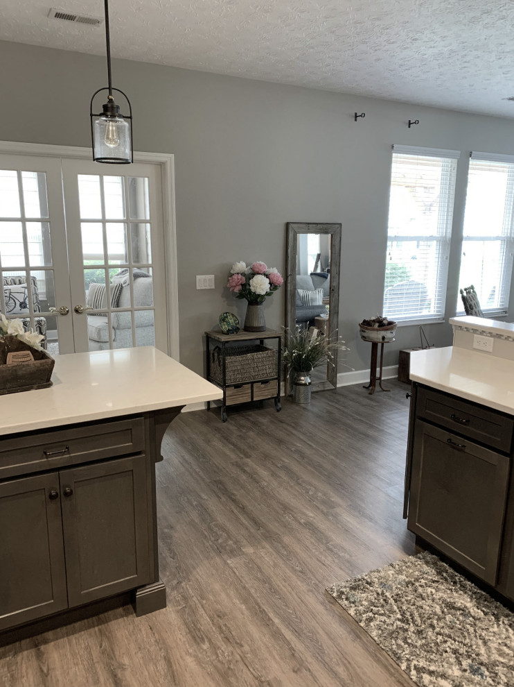 Large transitional u-shaped vinyl floor and gray floor open concept kitchen photo with an undermount sink, shaker cabinets, gray cabinets, quartz countertops, gray backsplash, ceramic backsplash, stainless steel appliances, a peninsula and white countertops