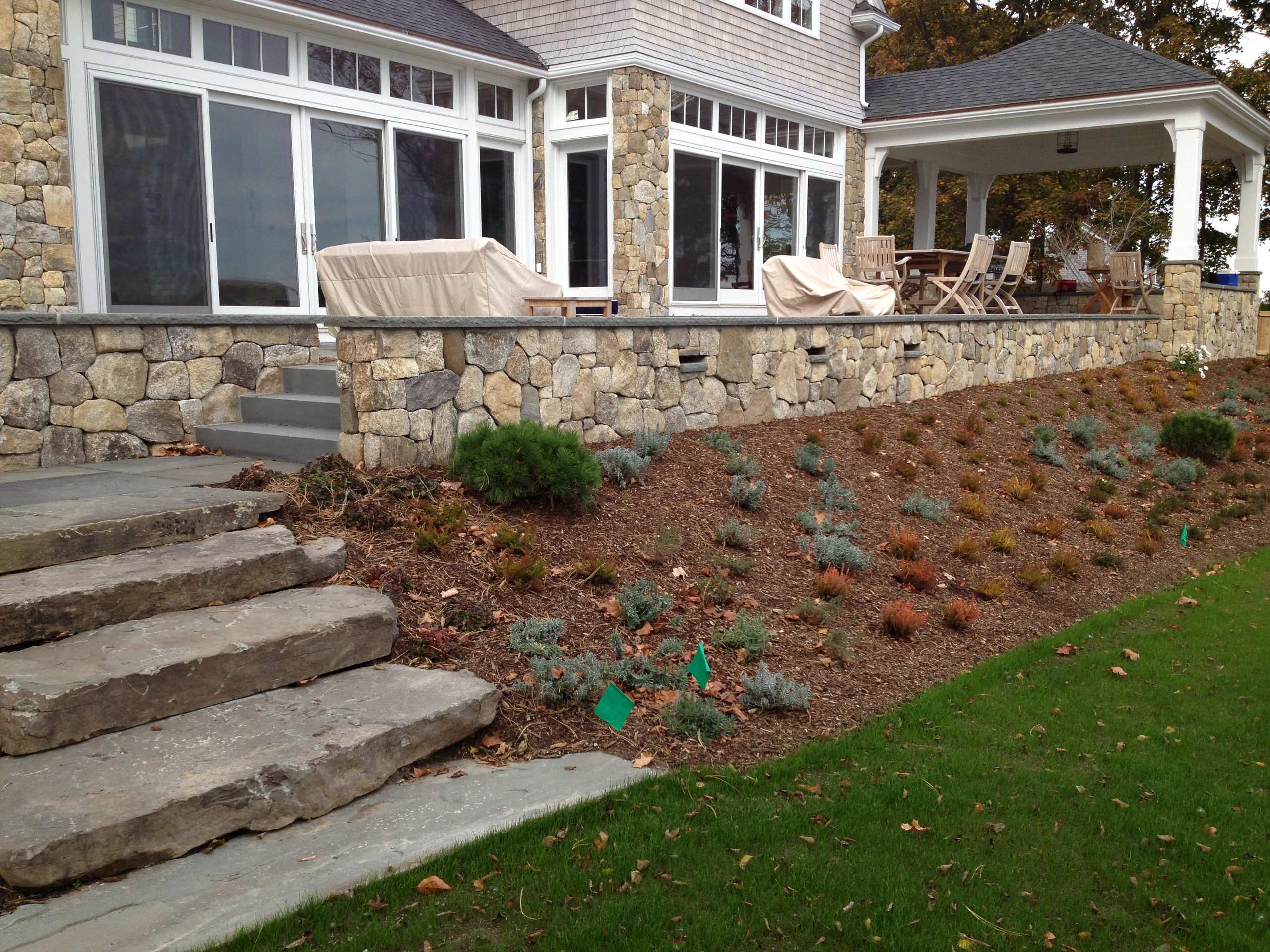 Massive stone steps lead from lawn to bluestone landing