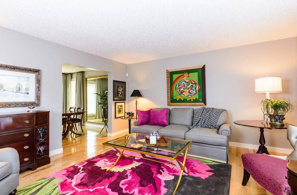 Inspiration for a mid-sized transitional formal and open concept light wood floor living room remodel in Calgary with gray walls, no fireplace and no tv
