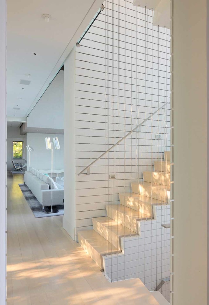 Inspiration for a contemporary wood staircase in New York with wood risers.