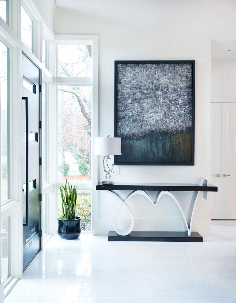 Design ideas for a contemporary entryway in Nashville with white walls and white floor.
