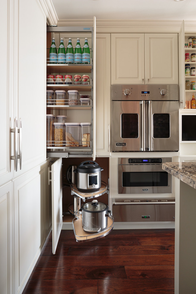 Transitional medium tone wood floor kitchen photo in Chicago with raised-panel cabinets and white cabinets