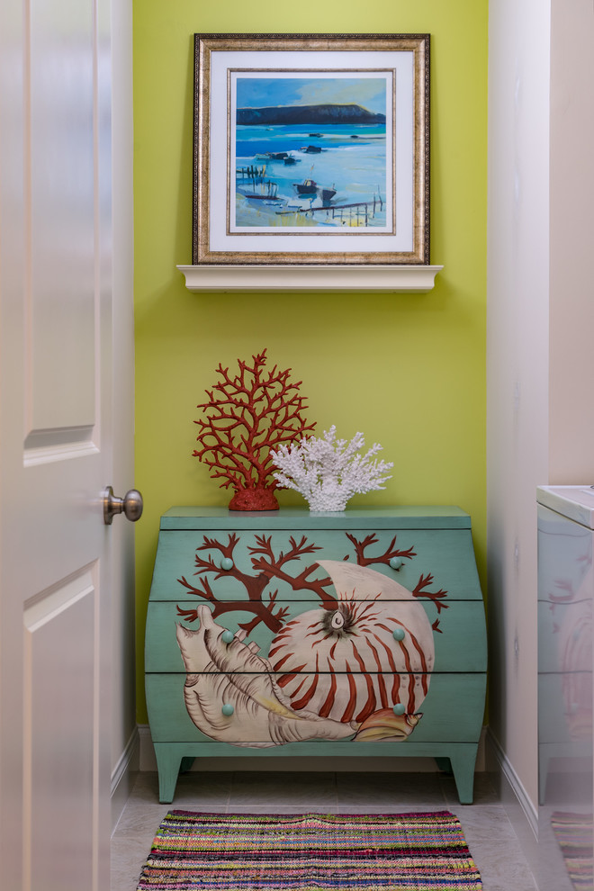 Inspiration for a small beach style single-wall laundry cupboard in Wilmington with yellow walls, ceramic floors and a side-by-side washer and dryer.