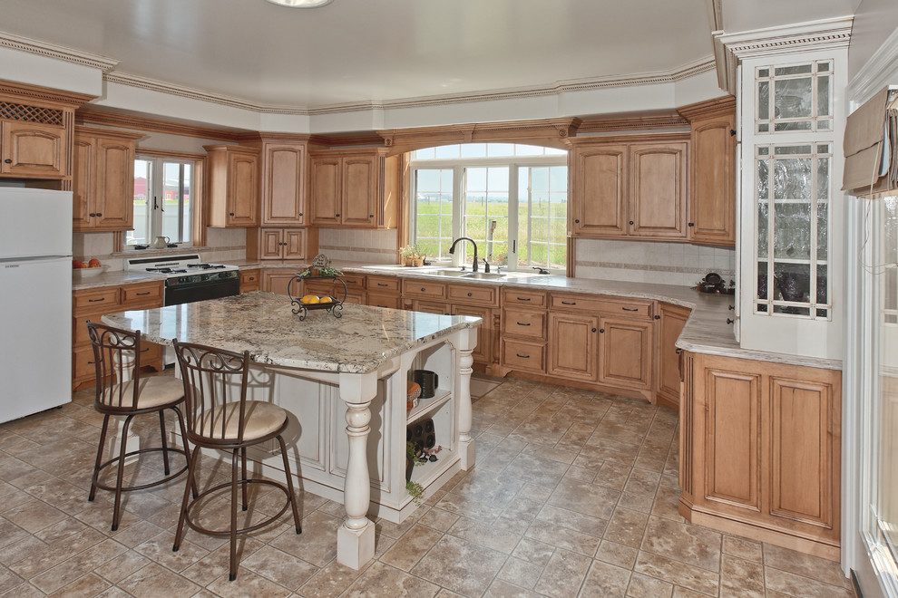 Mid-sized traditional u-shaped eat-in kitchen in Other with a double-bowl sink, raised-panel cabinets, medium wood cabinets, granite benchtops, beige splashback, porcelain splashback, stainless steel appliances, cement tiles, with island and brown floor.