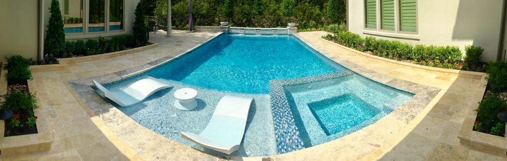 Inspiration for a large transitional backyard rectangular lap pool in Houston with a water feature and natural stone pavers.