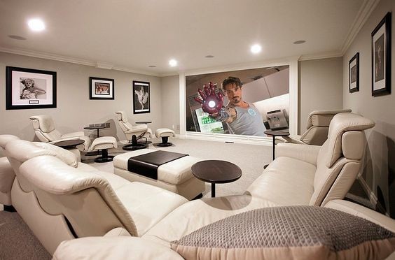 Photo of a mid-sized contemporary enclosed home theatre in San Diego with grey walls, carpet, a built-in media wall and white floor.
