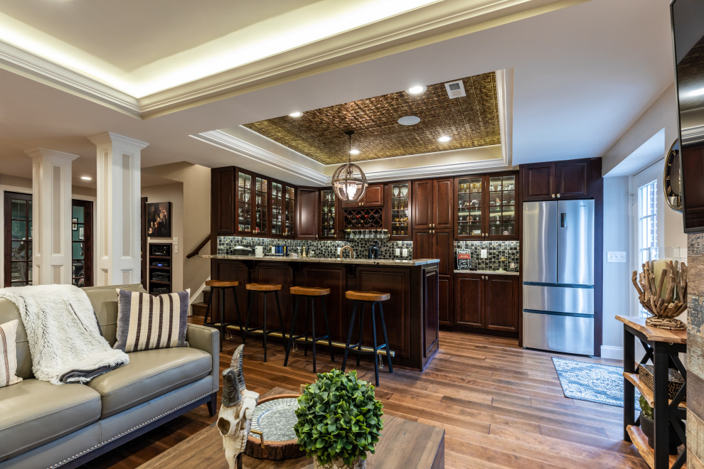 This is an example of a large contemporary walk-out basement in DC Metro with a standard fireplace, brown floor, recessed and decorative wall panelling.