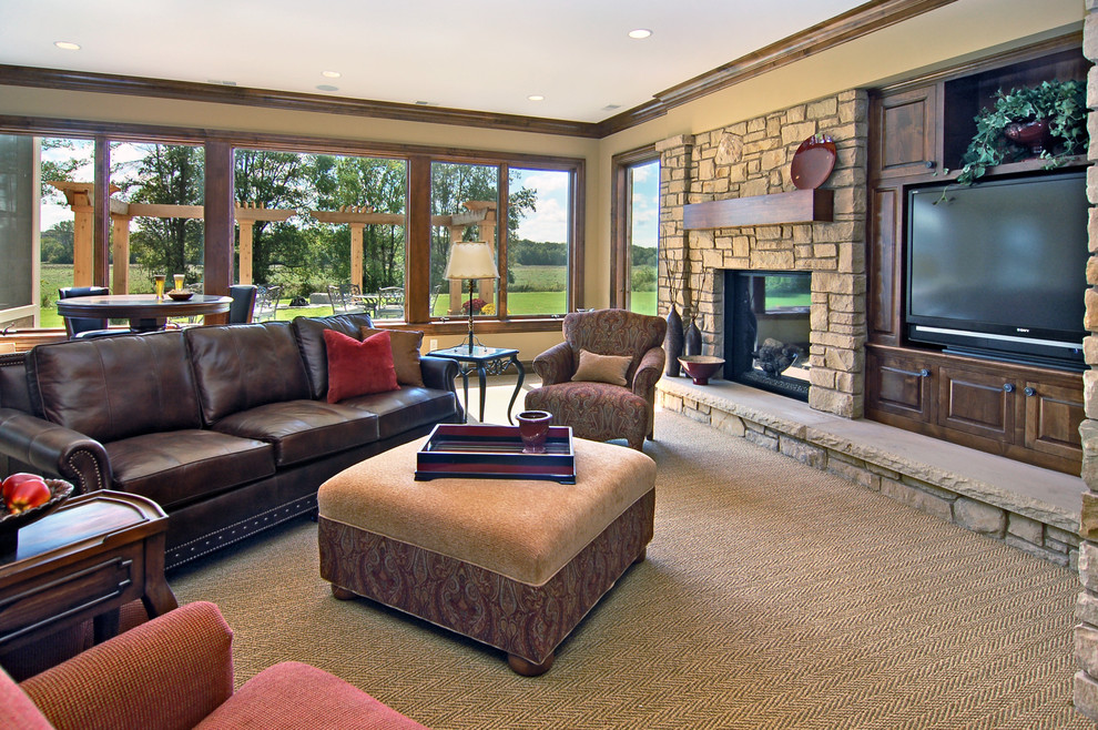 Photo of a traditional family room in Minneapolis with a stone fireplace surround.