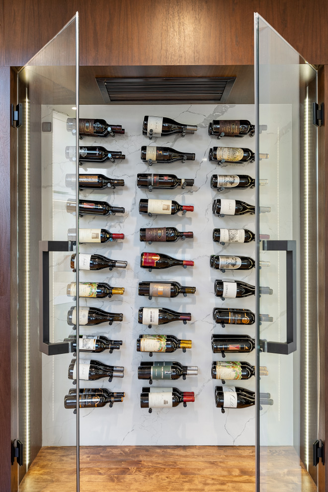 Expansive contemporary wine cellar in Los Angeles with display racks.