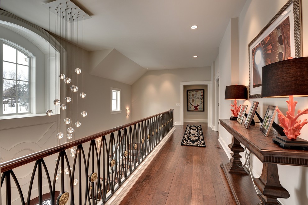 Inspiration for a traditional hallway in Minneapolis with white walls and dark hardwood floors.