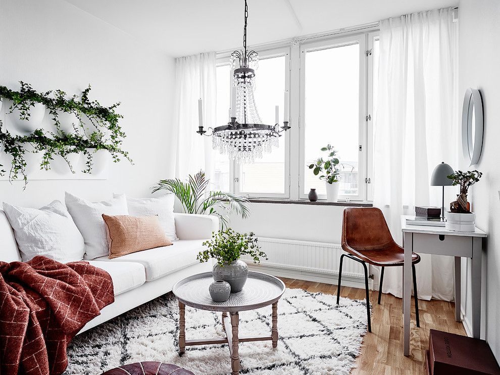 Inspiration for a small scandinavian enclosed living room in Gothenburg with white walls, light hardwood floors, no fireplace, no tv and beige floor.