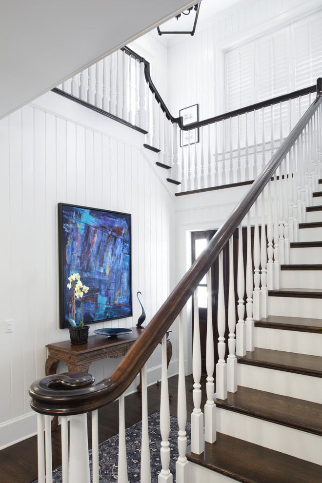 Photo of a large beach style wood u-shaped staircase in Jacksonville with wood risers.