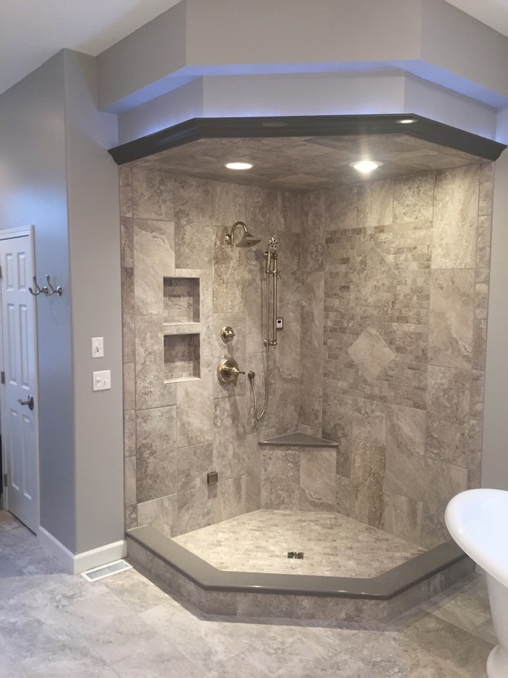 Photo of a mid-sized contemporary master bathroom in Other with a freestanding tub, an open shower, gray tile, stone tile, grey walls, ceramic floors, grey floor and an open shower.