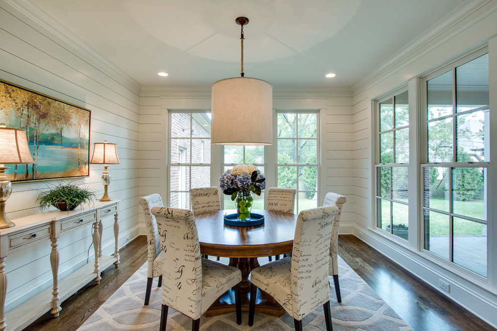This is an example of a mid-sized transitional separate dining room in Nashville with white walls, dark hardwood floors and no fireplace.