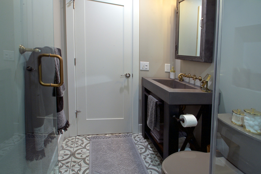 Photo of a small eclectic 3/4 bathroom in San Francisco with gray tile, grey walls, concrete floors, open cabinets, an alcove shower, a two-piece toilet, a console sink and concrete benchtops.
