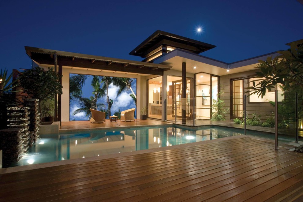 Example of a mid-sized minimalist backyard custom-shaped pool design