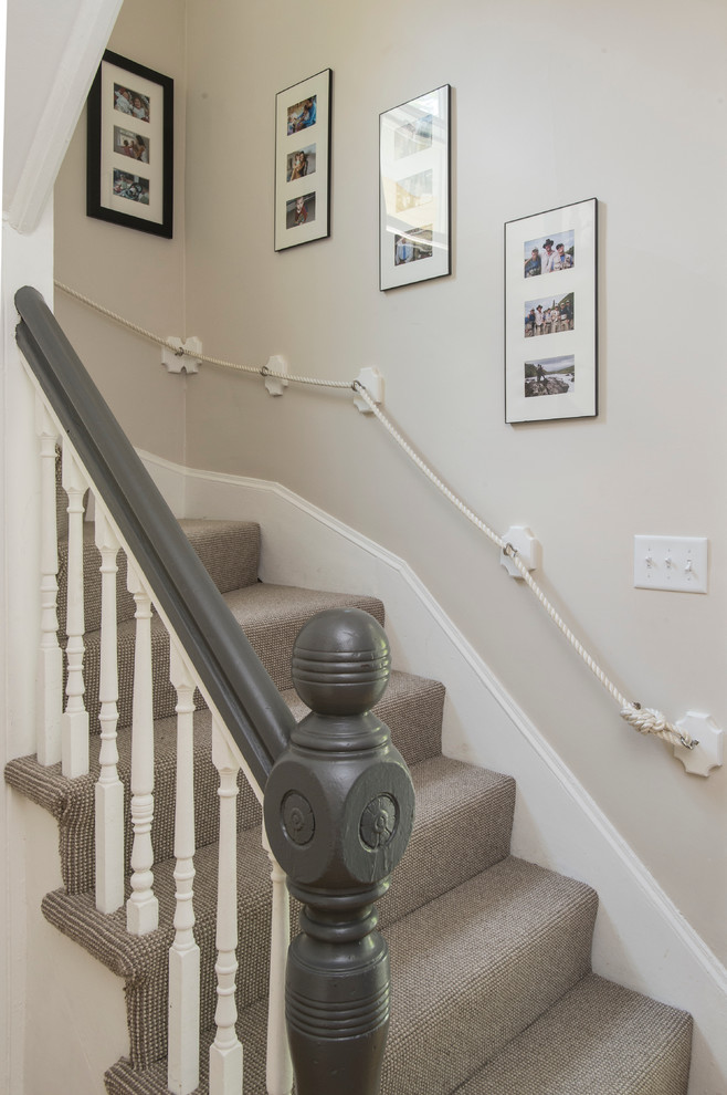 Photo of a small transitional carpeted curved staircase in Boston with carpet risers.