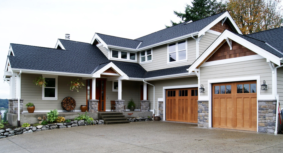 Design ideas for a mid-sized arts and crafts two-storey grey exterior in Seattle with mixed siding and a gable roof.
