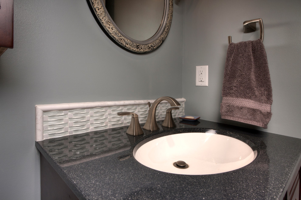 Design ideas for a mid-sized contemporary 3/4 bathroom in St Louis with an integrated sink, raised-panel cabinets, medium wood cabinets, onyx benchtops, a drop-in tub, a shower/bathtub combo, a one-piece toilet, multi-coloured tile, glass tile, multi-coloured walls and ceramic floors.