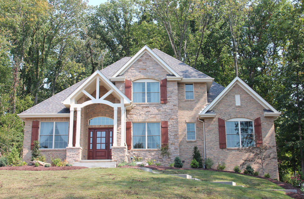 Mid-sized transitional beige two-story stone exterior home idea with a hip roof