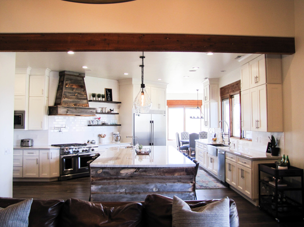 Kitchen - large transitional porcelain tile and brown floor kitchen idea in Phoenix with a farmhouse sink, white backsplash, subway tile backsplash, stainless steel appliances and an island