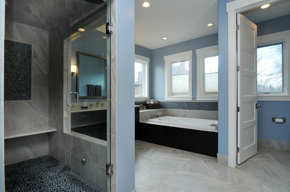 Photo of a mid-sized traditional bathroom in Denver with blue walls, an integrated sink, flat-panel cabinets, black cabinets, a drop-in tub, multi-coloured tile and with a sauna.