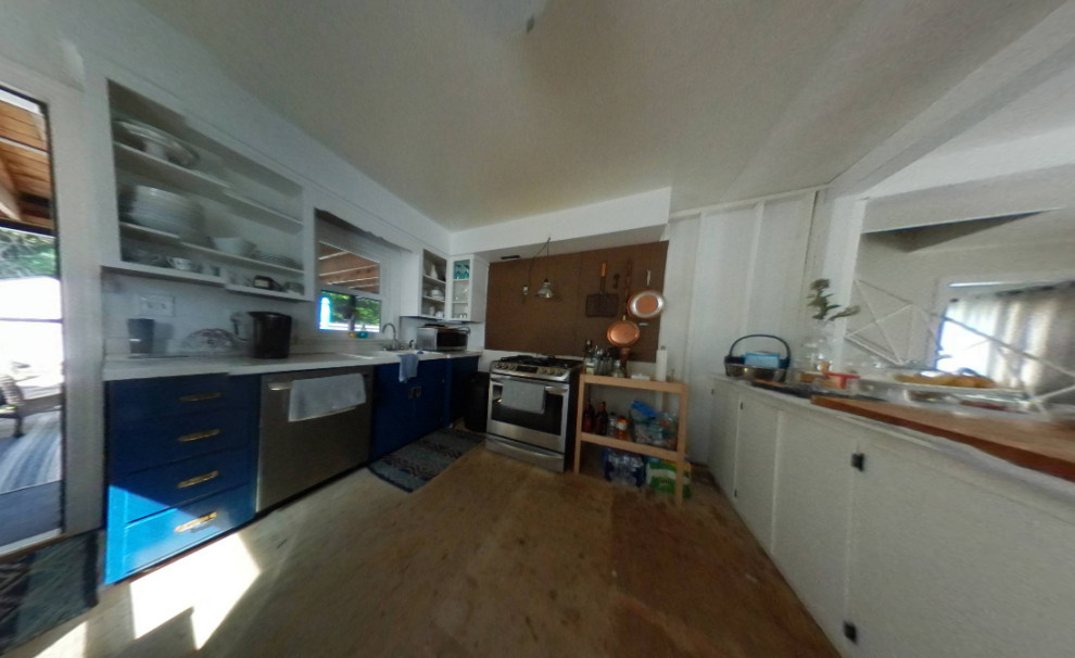 Inspiration for a large modern laminate floor eat-in kitchen remodel in Philadelphia with shaker cabinets, white cabinets, white backsplash, stainless steel appliances and a peninsula