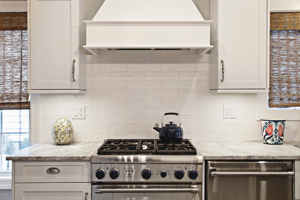 Example of a transitional kitchen design in New York with white backsplash