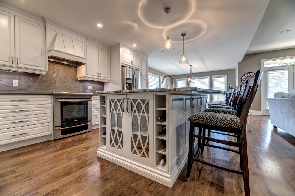 Transitional kitchen photo with brown backsplash and beige countertops