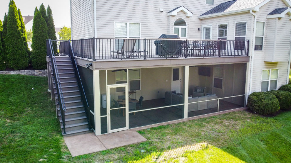 Example of a mid-sized backyard second story privacy and metal railing deck design in St Louis