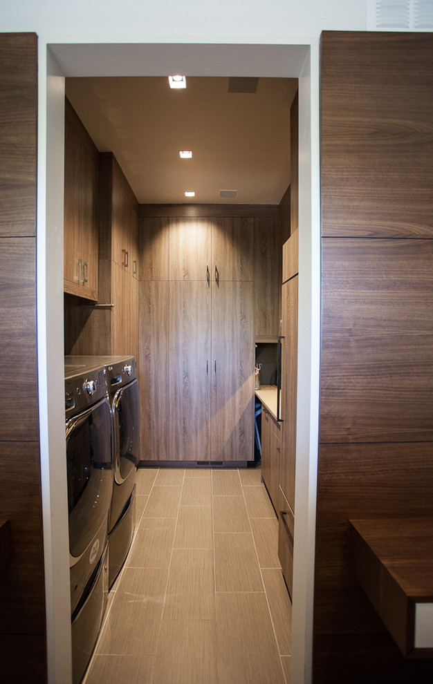 Inspiration for a contemporary u-shaped laundry room in Denver with flat-panel cabinets and medium wood cabinets.