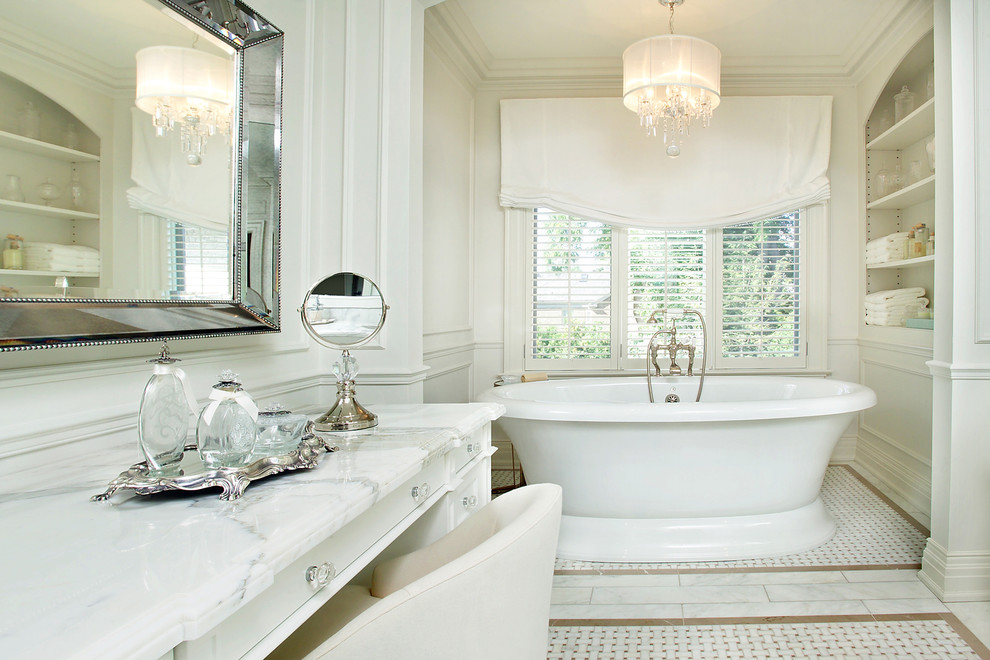 This is an example of a traditional bathroom in Toronto with white cabinets, a freestanding tub and recessed-panel cabinets.