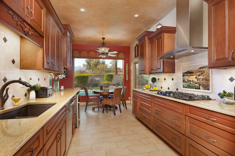 Kitchen - transitional travertine floor kitchen idea in Phoenix with a drop-in sink, raised-panel cabinets, medium tone wood cabinets, granite countertops, beige backsplash, stone tile backsplash and stainless steel appliances