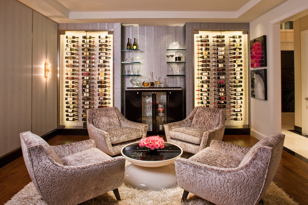 This is an example of a large contemporary wine cellar in Los Angeles with dark hardwood floors, storage racks and brown floor.