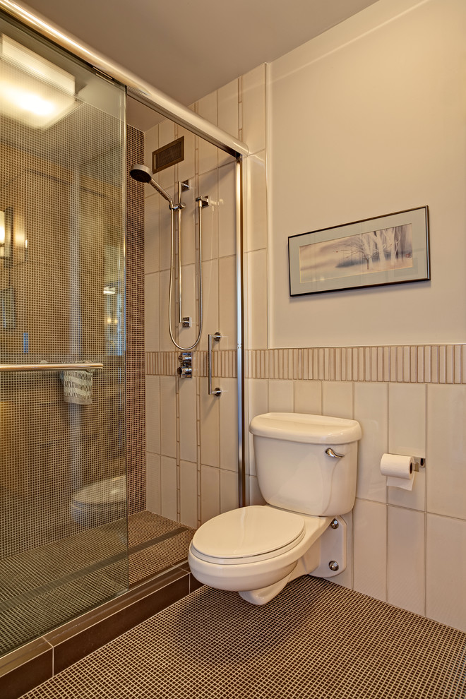 Photo of a small contemporary 3/4 bathroom in San Francisco with an undermount sink, flat-panel cabinets, medium wood cabinets, solid surface benchtops, white tile, ceramic tile, white walls, mosaic tile floors, an open shower, a wall-mount toilet, brown floor and a sliding shower screen.