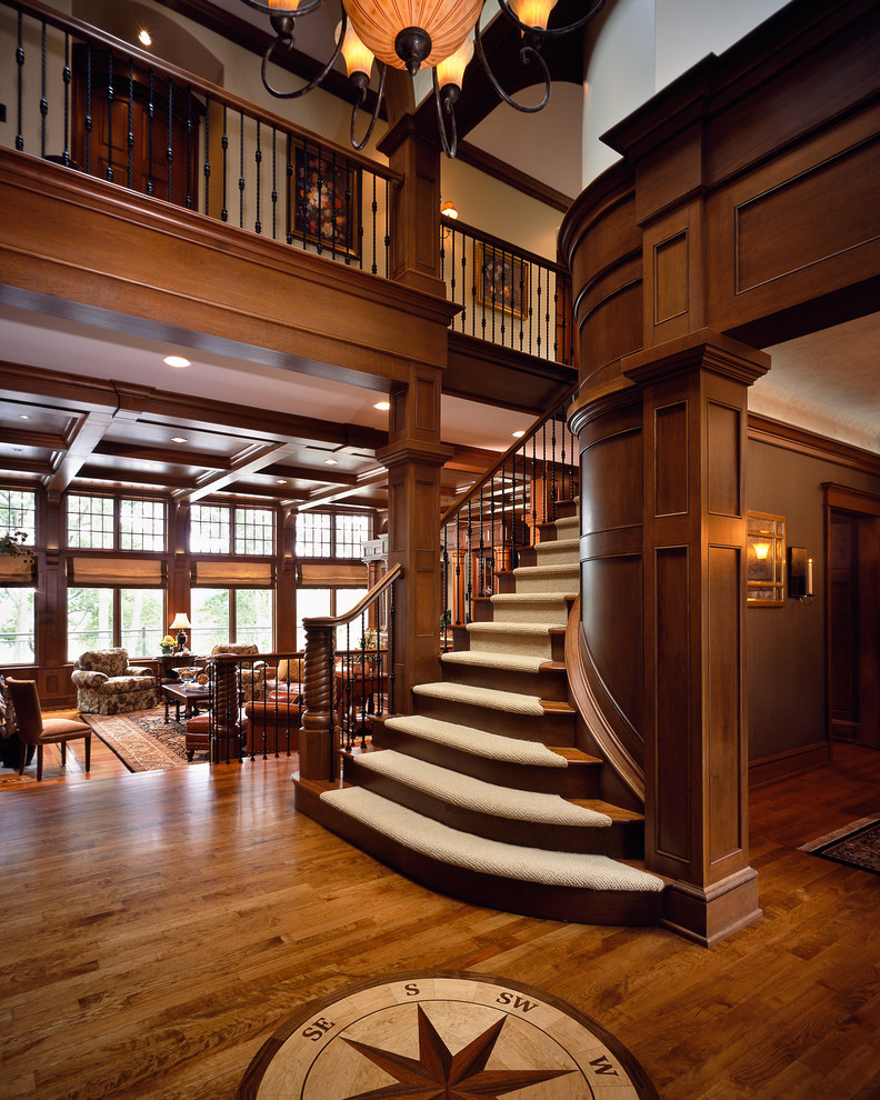 Photo of a mid-sized traditional carpeted curved staircase in Boston with wood risers and wood railing.