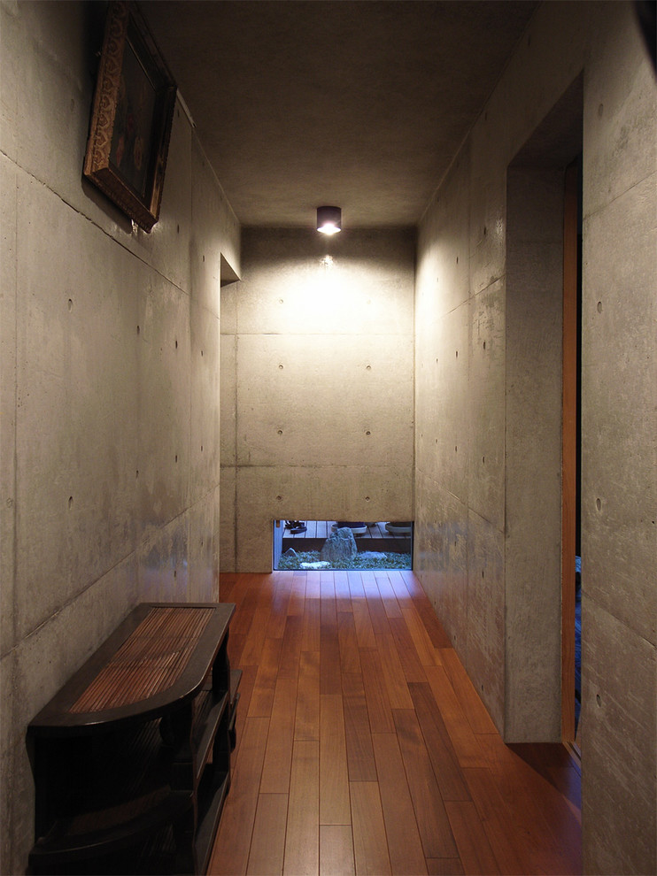 Inspiration for a modern hallway in Tokyo Suburbs with grey walls and dark hardwood floors.