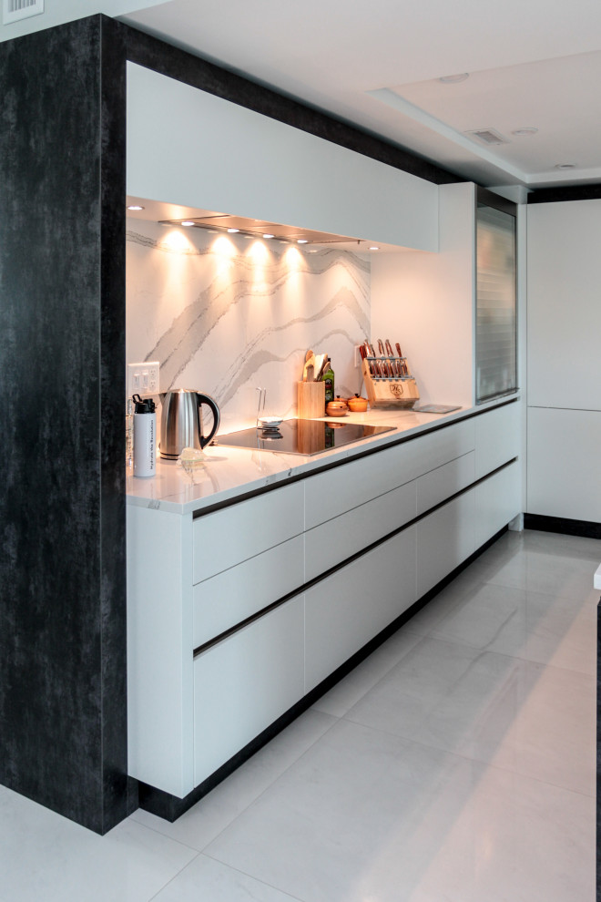 This is an example of a medium sized contemporary l-shaped open plan kitchen in Atlanta with a submerged sink, flat-panel cabinets, white cabinets, engineered stone countertops, white splashback, engineered quartz splashback, stainless steel appliances, porcelain flooring, an island, grey floors and yellow worktops.