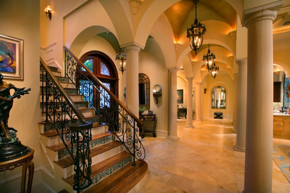 Design ideas for an expansive mediterranean foyer in Miami with beige walls, marble floors, a double front door and a glass front door.