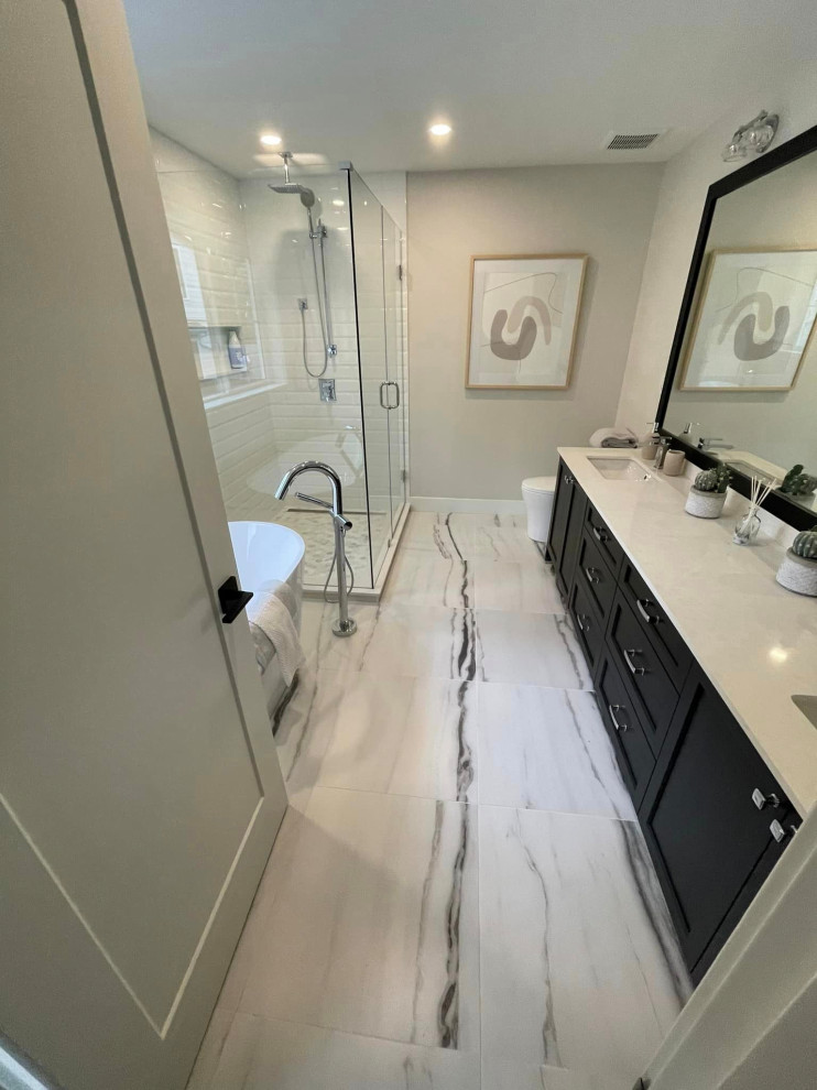 This is an example of a small modern master bathroom in Vancouver with dark wood cabinets, a claw-foot tub, a curbless shower, porcelain floors, a drop-in sink, multi-coloured floor, a hinged shower door, a double vanity and a built-in vanity.
